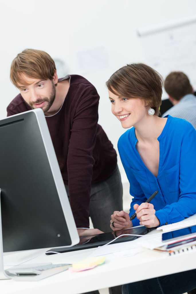Male and female IT support co-workers at the office