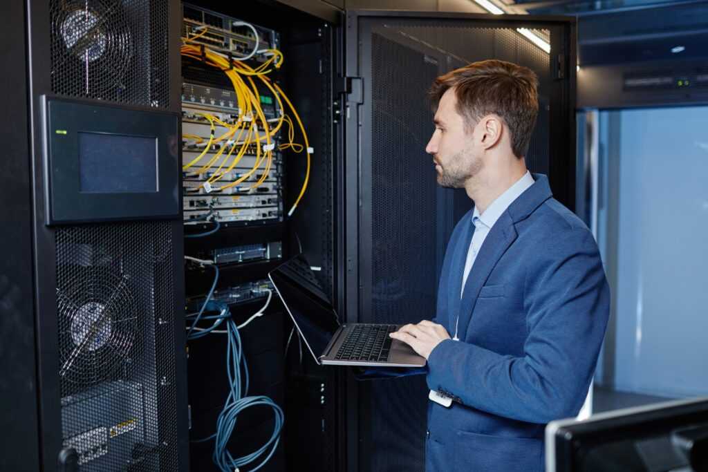 IT Manager with LapTop in Server Room