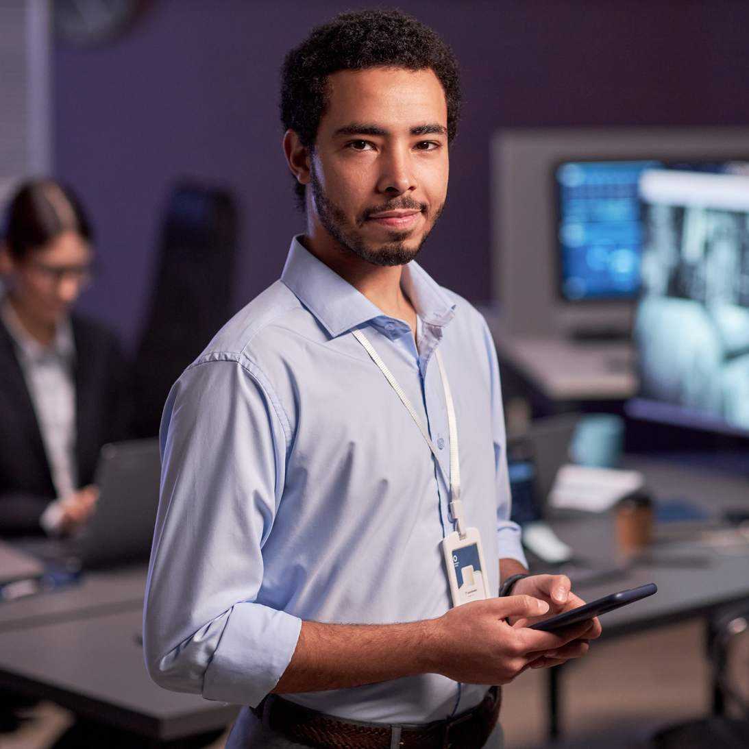 IT professional Standing With Phone In Hand IT professional Standing With Phone In Hand