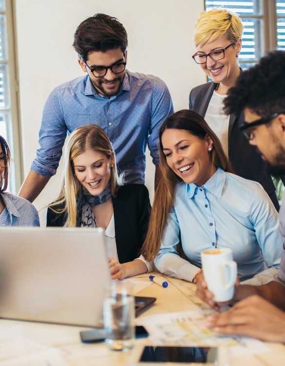 Business Professionals Smiling While Seeing Laptop