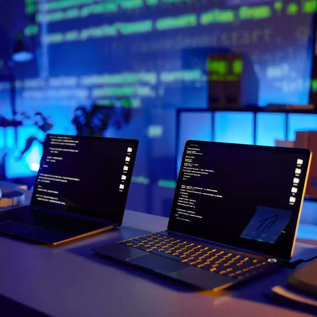 Laptops with Code on Screens
