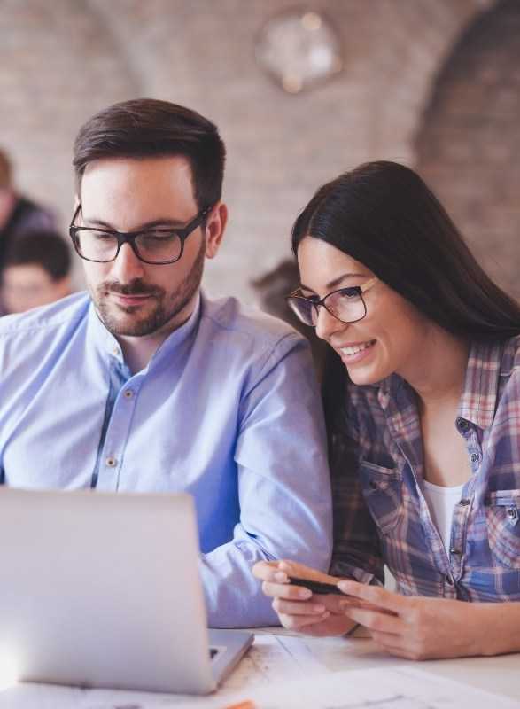 Professionals Working Together On Laptop