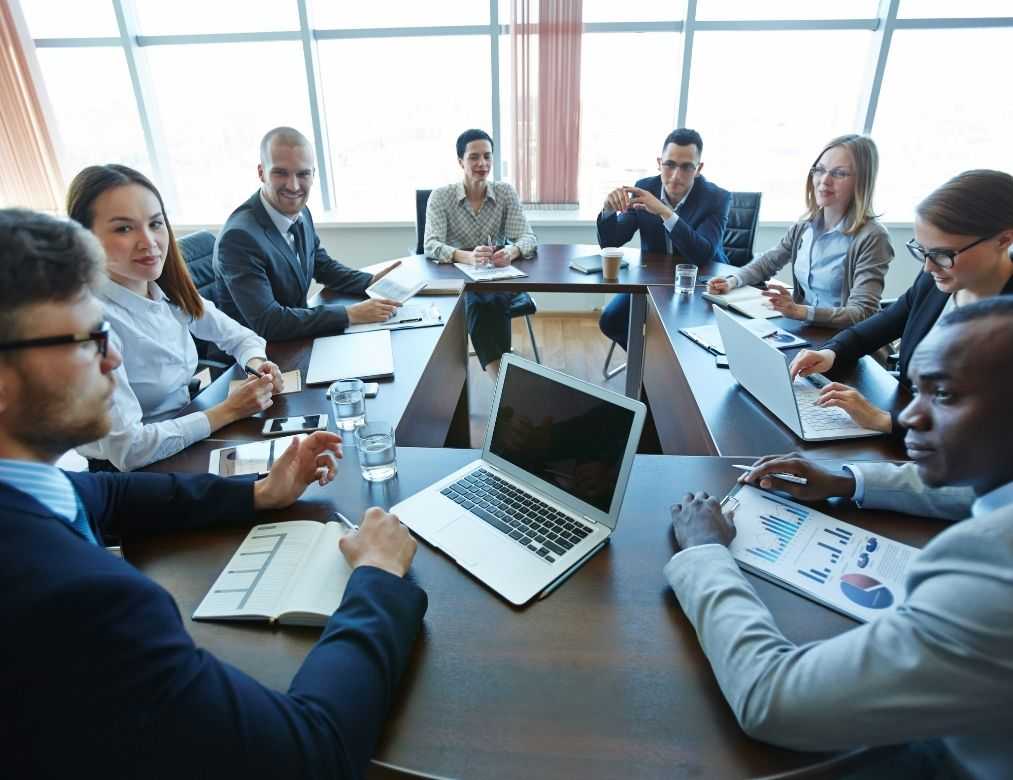 Business Colleagues Collaborating On Laptop With Documents And Charts