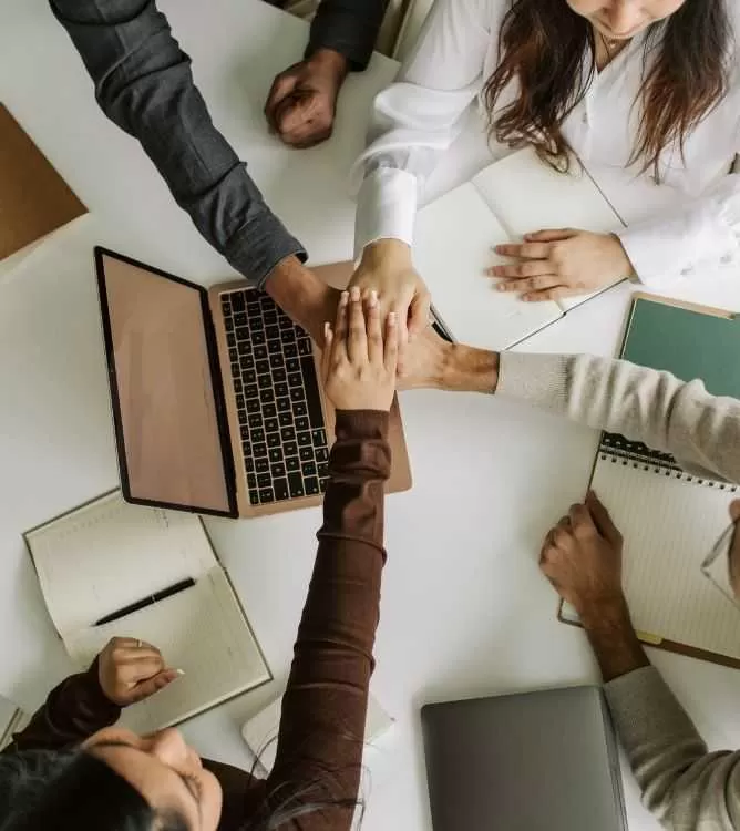 Business Team Joining Hands in Unity