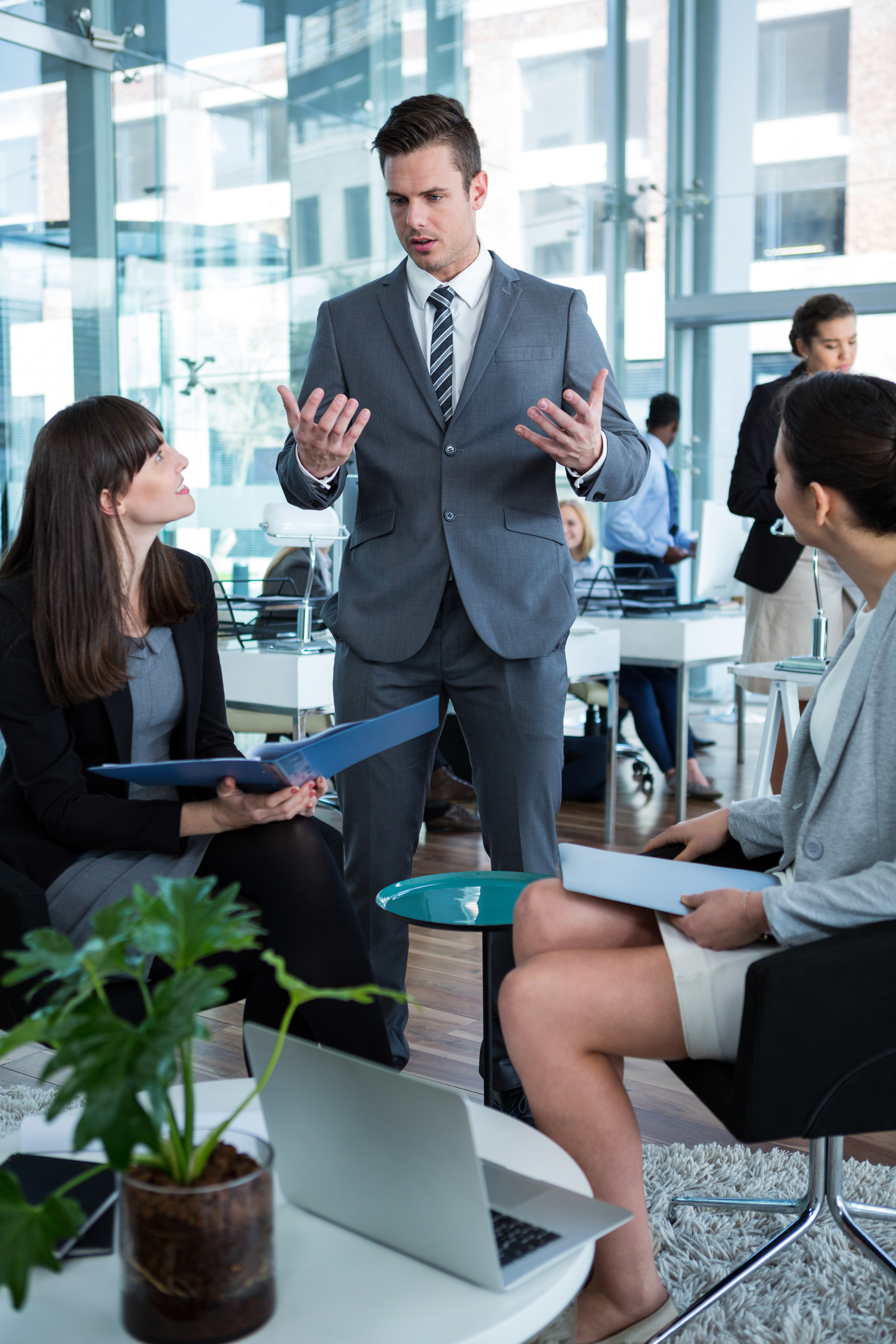 Businesspeople Discussing Over Document At Table In The Office