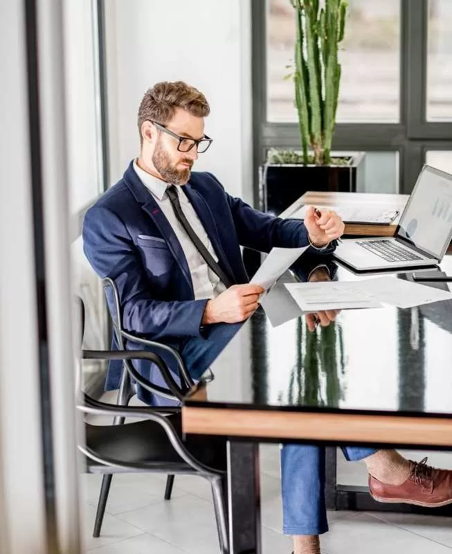 Man in Suit Reviewing Documents