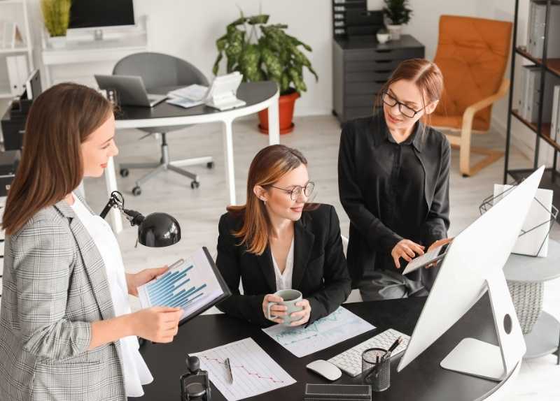Three Businesswomen Discussing Charts