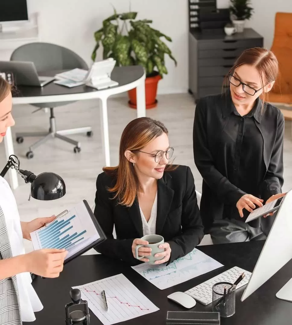 Three Professionals Discussing Business Plans in an Office
