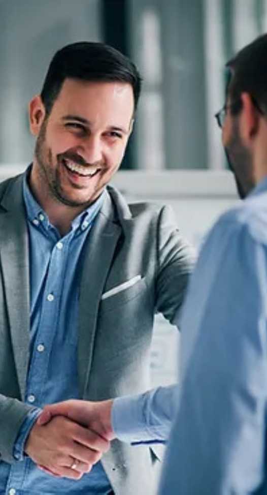 Two Employee Shaking Hands In Office