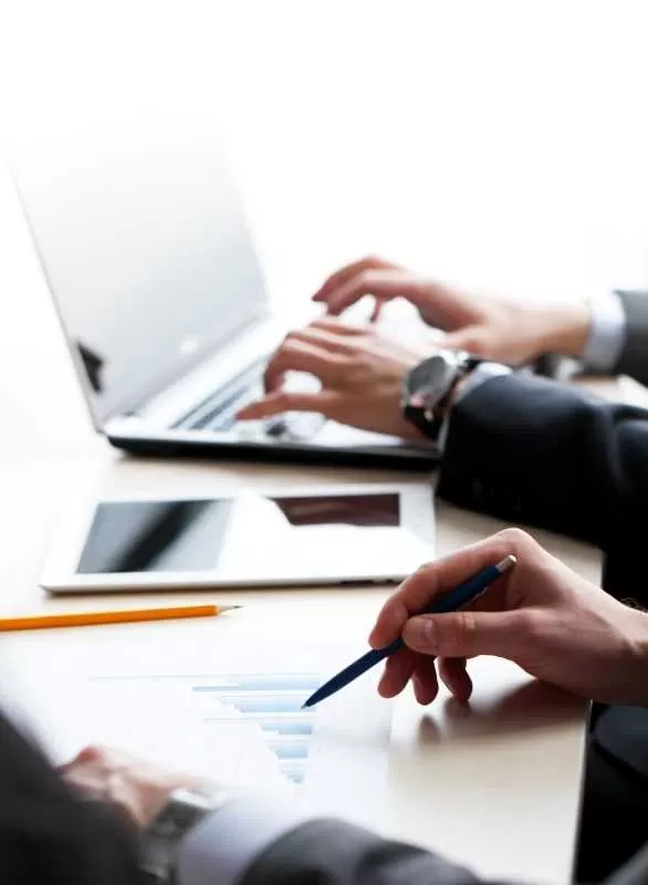 Two People Working on a Laptop and Documents
