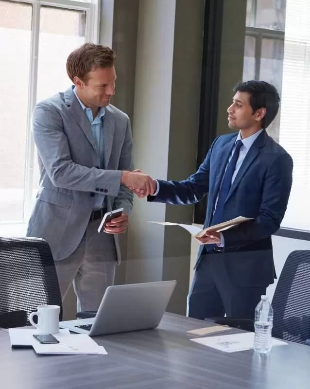 IT Business Professionals Shaking Hands In Office<br />
