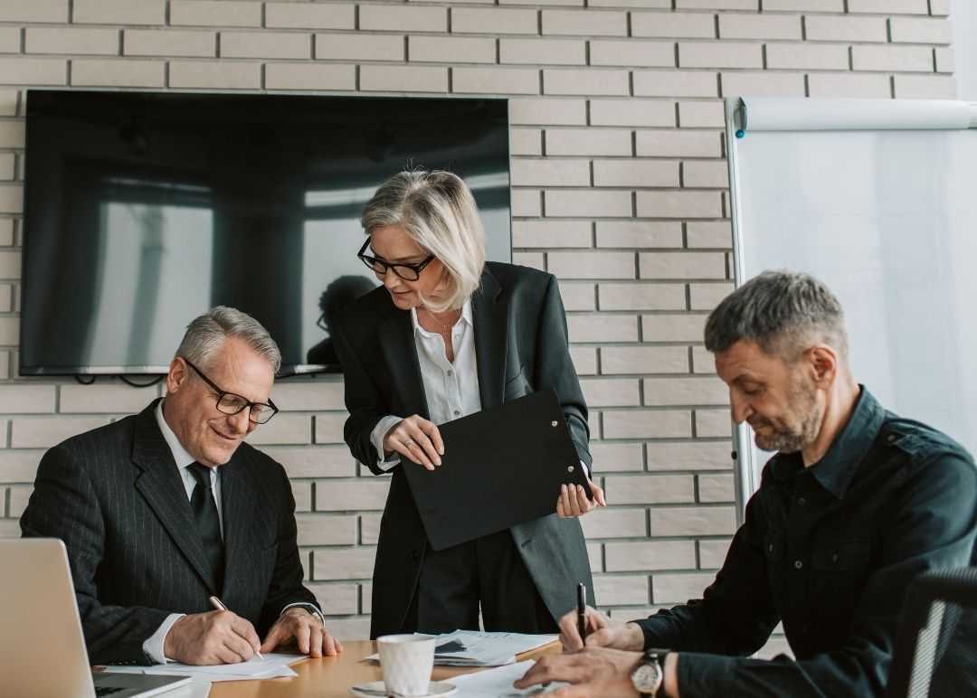  Business Professionals Reviewing Documents Together 