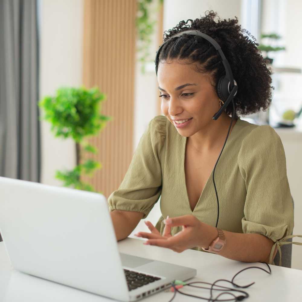  Woman Working On Laptop With Headset 