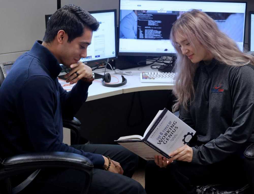 Business Colleagues Collaborating On Laptop With Documents And Charts