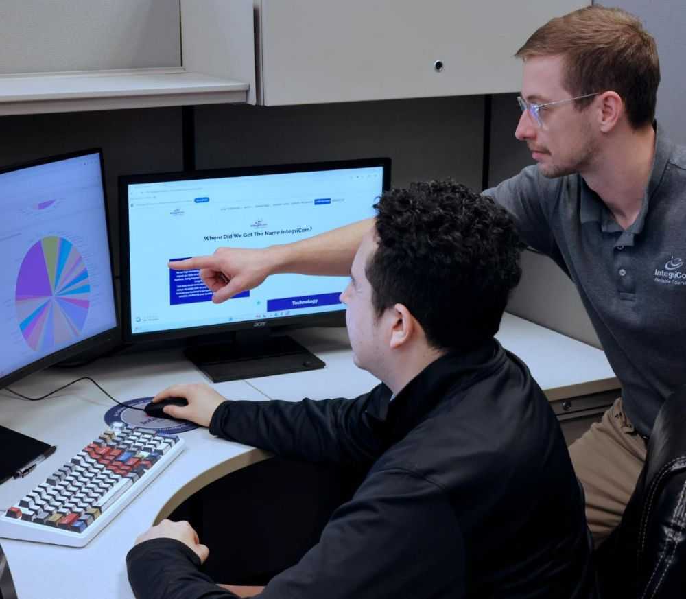 Woman Talking on Phone While Using Laptop