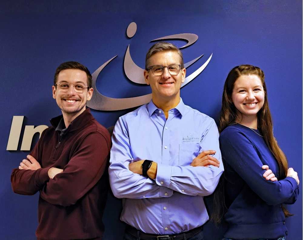 Integricom Leadership Team Standing Together In Office