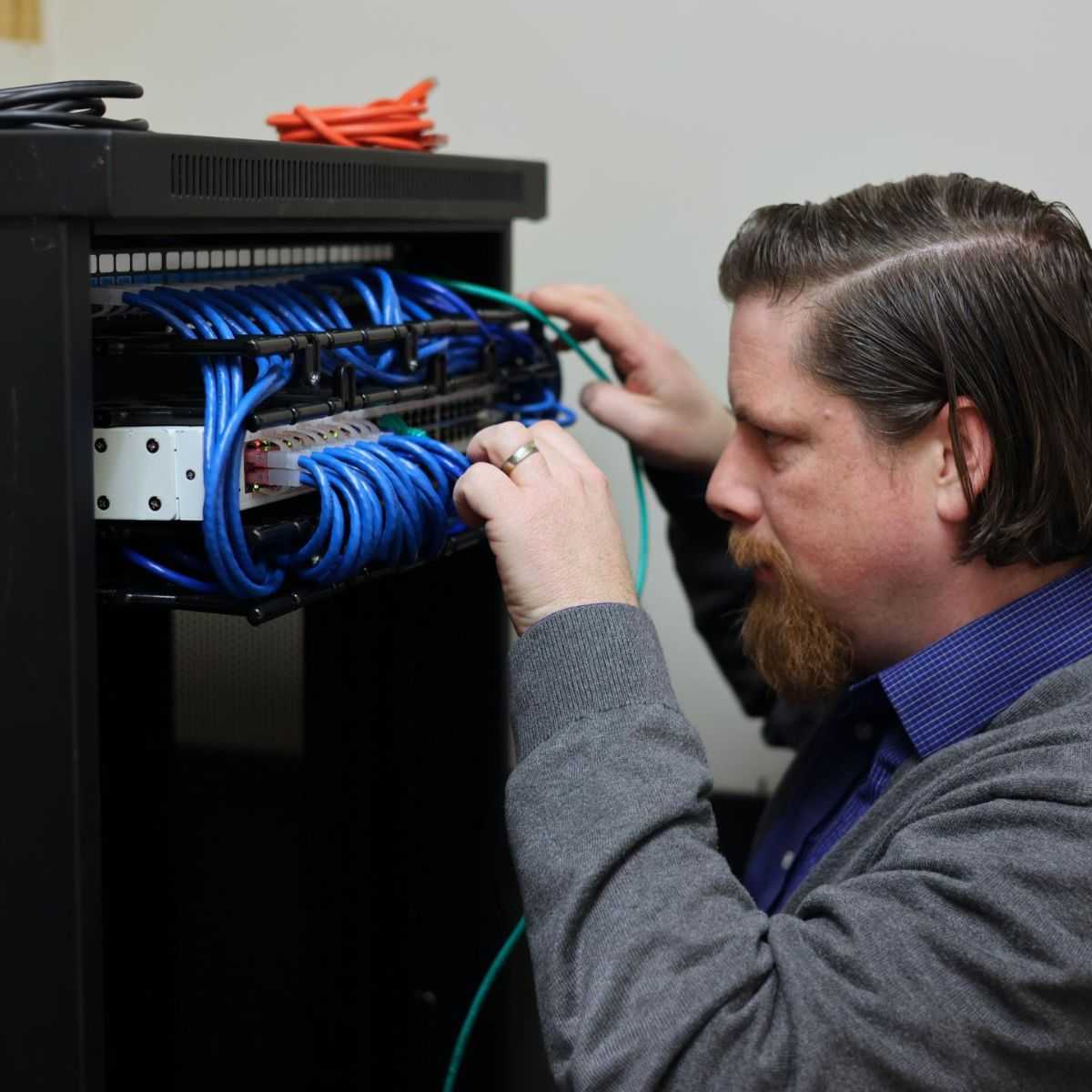 Technician Managing Network Server Cables