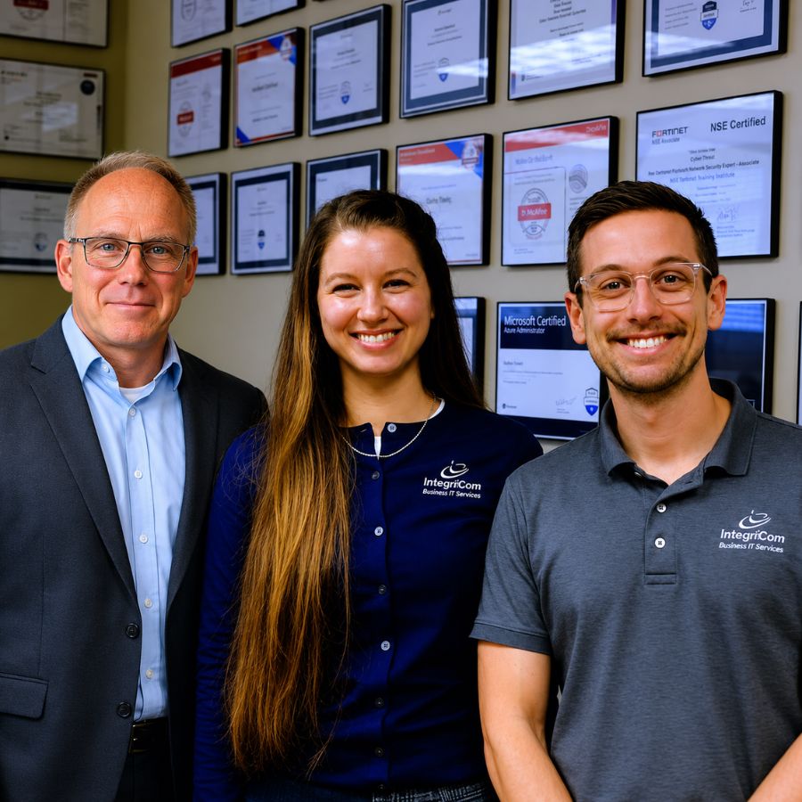 Integricom Leadership Team Standing Together In Office